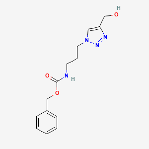molecular formula C14H18N4O3 B1480649 benzyl (3-(4-(hydroxymethyl)-1H-1,2,3-triazol-1-yl)propyl)carbamate CAS No. 2098111-26-1