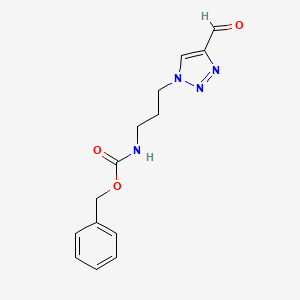 molecular formula C14H16N4O3 B1482972 benzyl (3-(4-formyl-1H-1,2,3-triazol-1-yl)propyl)carbamate CAS No. 2098071-34-0