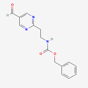 molecular formula C15H15N3O3 B14844686 Benzyl (2-(5-formylpyrimidin-2-yl)ethyl)carbamate CAS No. 944899-64-3