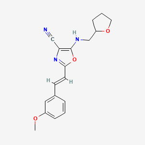 molecular formula C18H19N3O3 B14990196 2-[(E)-2-(3-methoxyphenyl)ethenyl]-5-[(tetrahydrofuran-2-ylmethyl)amino]-1,3-oxazole-4-carbonitrile 