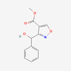 molecular formula C12H11NO4 B15046667 Methyl 3-[Hydroxy(phenyl)methyl]isoxazole-4-carboxylate 