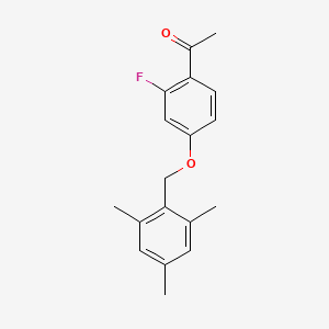 molecular formula C18H19FO2 B1526406 1-{2-Fluoro-4-[(2,4,6-trimethylphenyl)methoxy]phenyl}ethan-1-one CAS No. 1389653-59-1