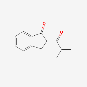 molecular formula C13H14O2 B15273855 2-(2-Methylpropanoyl)-2,3-dihydro-1H-inden-1-one 