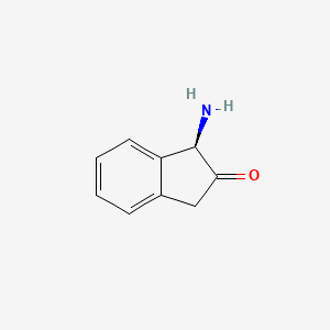 (R)-1-Amino-1H-inden-2(3H)-one