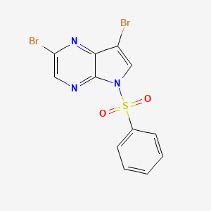 molecular formula C12H7Br2N3O2S B15333478 2,7-Dibromo-5-(phenylsulfonyl)-5H-pyrrolo[2,3-b]pyrazine 