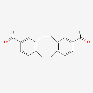 molecular formula C18H16O2 B15337251 5,6,11,12-Tetrahydrodibenzo[a,e][8]annulene-2,9-dicarbaldehyde 