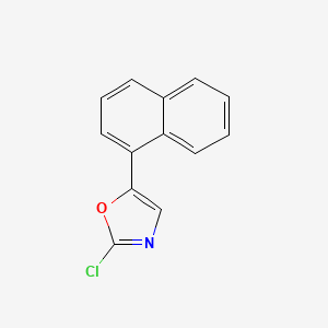 molecular formula C13H8ClNO B15337459 2-Chloro-5-(1-naphthyl)oxazole 