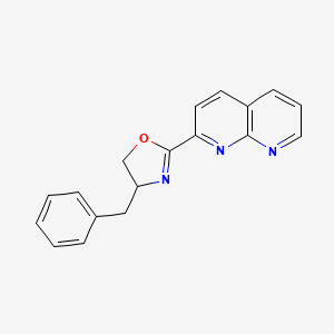 molecular formula C18H15N3O B15351326 4-Benzyl-2-(1,8-naphthyridin-2-yl)-4,5-dihydro-1,3-oxazole 