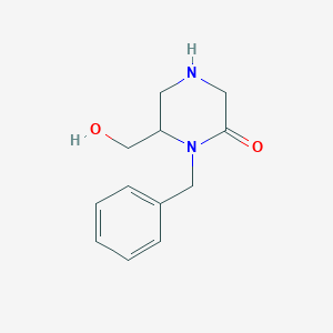 molecular formula C12H16N2O2 B15377953 1-Benzyl-6-(hydroxymethyl)piperazin-2-one 