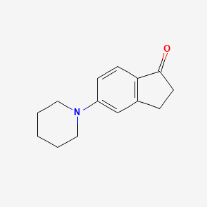 B1612954 5-(Piperidin-1-yl)-2,3-dihydro-1H-inden-1-one CAS No. 808756-85-6