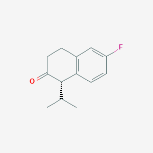 molecular formula C13H15FO B168322 (S)-6-Fluoro-1-isopropyl-3,4-dihydronaphthalen-2(1H)-one CAS No. 104205-01-8