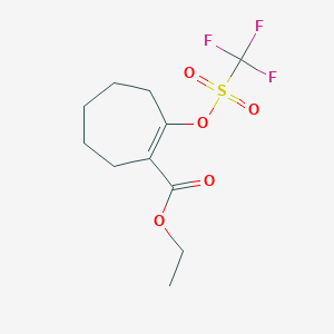 molecular formula C11H15F3O5S B174721 Ethyl 2-(((trifluoromethyl)sulfonyl)oxy)cyclohept-1-enecarboxylate CAS No. 144242-09-1