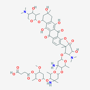 molecular formula C60H86N4O22 B238301 4-[6-[4-Amino-6-[4-amino-6-[[23-(dimethylamino)-10-[5-(dimethylamino)-4-hydroxy-3-methyloxan-2-yl]oxy-8,12,15,22-tetrahydroxy-1,12-dimethyl-6,17-dioxo-20,25-dioxahexacyclo[19.3.1.02,19.05,18.07,16.09,14]pentacosa-2(19),3,5(18),7,9(14),15-hexaen-24-yl]oxy]-2,4-dimethyloxan-3-yl]oxy-2,4-dimethyloxan-3-yl]oxy-4-methoxy-2-methyloxan-3-yl]oxy-4-oxobutanoic acid CAS No. 135447-13-1