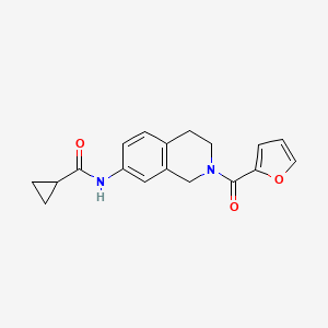 molecular formula C18H18N2O3 B2390774 N-(2-(furan-2-carbonyl)-1,2,3,4-tetrahydroisoquinolin-7-yl)cyclopropanecarboxamide CAS No. 955741-67-0
