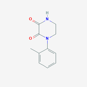 1-(2-Methylphenyl)piperazine-2,3-dione