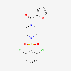 molecular formula C15H14Cl2N2O4S B2463965 1-[(2,6-Dichlorophenyl)sulfonyl]-4-(2-furoyl)piperazine CAS No. 670272-49-8