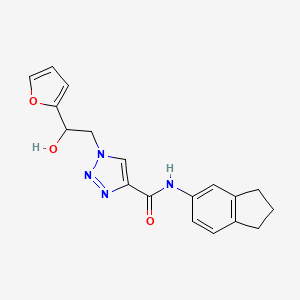 molecular formula C18H18N4O3 B2482968 N-(2,3-dihydro-1H-inden-5-yl)-1-(2-(furan-2-yl)-2-hydroxyethyl)-1H-1,2,3-triazole-4-carboxamide CAS No. 2034534-53-5
