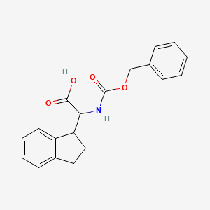 molecular formula C19H19NO4 B2521359 2-(2,3-Dihydro-1H-inden-1-yl)-2-(phenylmethoxycarbonylamino)acetic acid CAS No. 2287267-92-7