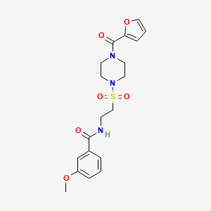 molecular formula C19H23N3O6S B2537443 N-[2-[4-(furan-2-carbonyl)piperazin-1-yl]sulfonylethyl]-3-methoxybenzamide CAS No. 899979-23-8