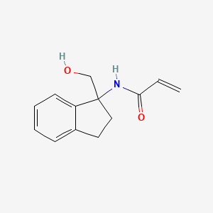 molecular formula C13H15NO2 B2540870 N-[1-(Hydroxymethyl)-2,3-dihydroinden-1-yl]prop-2-enamide CAS No. 2411249-93-7