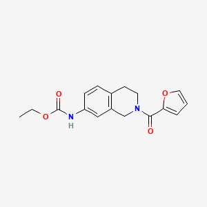 molecular formula C17H18N2O4 B2560192 Ethyl (2-(furan-2-carbonyl)-1,2,3,4-tetrahydroisoquinolin-7-yl)carbamate CAS No. 955666-13-4