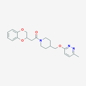 molecular formula C21H25N3O4 B2576174 2-(2,3-Dihydro-1,4-benzodioxin-3-yl)-1-[4-[(6-methylpyridazin-3-yl)oxymethyl]piperidin-1-yl]ethanone CAS No. 2415565-32-9