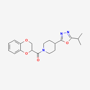 molecular formula C19H23N3O4 B2604706 (2,3-Dihydrobenzo[b][1,4]dioxin-2-yl)(4-(5-isopropyl-1,3,4-oxadiazol-2-yl)piperidin-1-yl)methanone CAS No. 1209454-71-6
