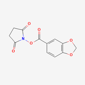 molecular formula C12H9NO6 B2605545 1-[(1,3-苯并二氧杂环-5-羰基)氧基]吡咯烷-2,5-二酮 CAS No. 102132-54-7