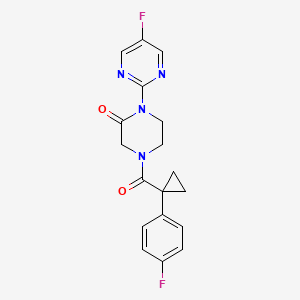 molecular formula C18H16F2N4O2 B2608365 4-[1-(4-Fluorophenyl)cyclopropanecarbonyl]-1-(5-fluoropyrimidin-2-yl)piperazin-2-one CAS No. 2320861-29-6