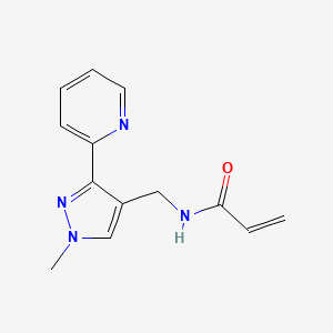molecular formula C13H14N4O B2653272 N-[(1-Methyl-3-pyridin-2-ylpyrazol-4-yl)methyl]prop-2-enamide CAS No. 2411252-04-3