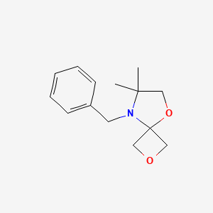 molecular formula C14H19NO2 B2702537 8-Benzyl-7,7-dimethyl-2,5-dioxa-8-azaspiro[3.4]octane CAS No. 1556097-39-2