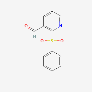 molecular formula C13H11NO3S B2722537 2-[(4-甲基苯基)磺酰基]吡啶-3-甲醛 CAS No. 1630763-40-4