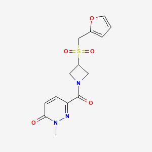 molecular formula C14H15N3O5S B2732991 6-(3-((furan-2-ylmethyl)sulfonyl)azetidine-1-carbonyl)-2-methylpyridazin-3(2H)-one CAS No. 1797178-38-1