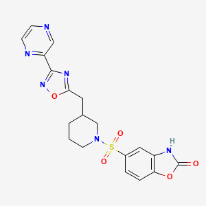 molecular formula C19H18N6O5S B2762072 5-((3-((3-(pyrazin-2-yl)-1,2,4-oxadiazol-5-yl)methyl)piperidin-1-yl)sulfonyl)benzo[d]oxazol-2(3H)-one CAS No. 1705561-63-2