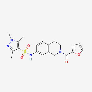 molecular formula C20H22N4O4S B2771107 N-(2-(furan-2-carbonyl)-1,2,3,4-tetrahydroisoquinolin-7-yl)-1,3,5-trimethyl-1H-pyrazole-4-sulfonamide CAS No. 1448076-87-6