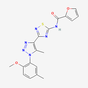 N-(3-(1-(2-methoxy-5-methylphenyl)-5-methyl-1H-1,2,3-triazol-4-yl)-1,2,4-thiadiazol-5-yl)furan-2-carboxamide