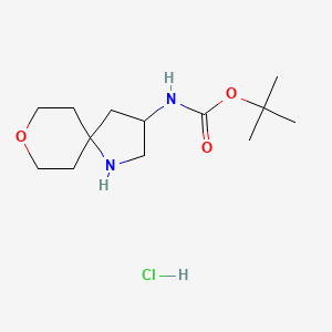 molecular formula C13H25ClN2O3 B2775943 叔丁基 (8-氧杂-1-氮杂螺[4.5]癸烷-3-基)氨基甲酸酯 盐酸盐 CAS No. 2219371-52-3