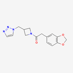 molecular formula C15H16N4O3 B2776732 2-(1,3-Benzodioxol-5-yl)-1-[3-(triazol-1-ylmethyl)azetidin-1-yl]ethanone CAS No. 2320465-38-9