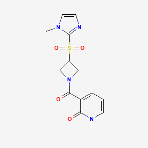 molecular formula C14H16N4O4S B2781200 1-methyl-3-(3-((1-methyl-1H-imidazol-2-yl)sulfonyl)azetidine-1-carbonyl)pyridin-2(1H)-one CAS No. 2320221-24-5