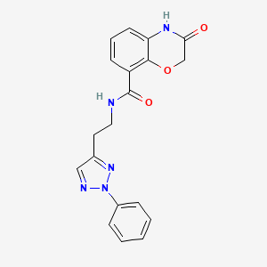 B2800367 3-Oxo-N-[2-(2-phenyltriazol-4-yl)ethyl]-4H-1,4-benzoxazine-8-carboxamide CAS No. 2419406-00-9