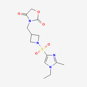 molecular formula C13H18N4O5S B2820396 3-((1-((1-乙基-2-甲基-1H-咪唑-4-基)磺酰)氮代)丙酸-3-基)氧杂环丁烷-2,4-二酮 CAS No. 2034610-84-7