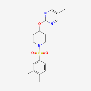 molecular formula C18H23N3O3S B2834260 2-[1-(3,4-Dimethylphenyl)sulfonylpiperidin-4-yl]oxy-5-methylpyrimidine CAS No. 2379983-94-3