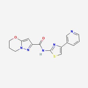 molecular formula C15H13N5O2S B2867639 N-(4-(pyridin-3-yl)thiazol-2-yl)-6,7-dihydro-5H-pyrazolo[5,1-b][1,3]oxazine-2-carboxamide CAS No. 1428365-78-9