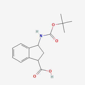 molecular formula C15H19NO4 B2899512 3-[(2-methylpropan-2-yl)oxycarbonylamino]-2,3-dihydro-1H-indene-1-carboxylic Acid CAS No. 1824234-11-8