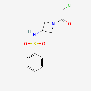 molecular formula C12H15ClN2O3S B2906760 N-[1-(2-Chloroacetyl)azetidin-3-yl]-4-methylbenzenesulfonamide CAS No. 2411315-43-8