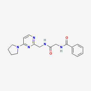 N-(2-oxo-2-(((4-(pyrrolidin-1-yl)pyrimidin-2-yl)methyl)amino)ethyl)benzamide