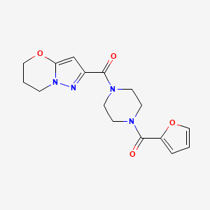 molecular formula C16H18N4O4 B2976676 (6,7-二氢-5H-吡唑并[5,1-b][1,3]恶嗪-2-基)(4-(呋喃-2-羰基)哌嗪-1-基)甲苯酮 CAS No. 1428365-85-8