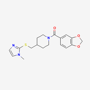 molecular formula C18H21N3O3S B2977388 benzo[d][1,3]dioxol-5-yl(4-(((1-methyl-1H-imidazol-2-yl)thio)methyl)piperidin-1-yl)methanone CAS No. 1428372-20-6