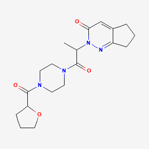 2-(1-oxo-1-(4-(tetrahydrofuran-2-carbonyl)piperazin-1-yl)propan-2-yl)-6,7-dihydro-2H-cyclopenta[c]pyridazin-3(5H)-one