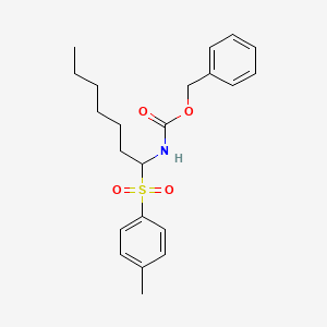 benzyl N-{1-[(4-methylphenyl)sulfonyl]heptyl}carbamate